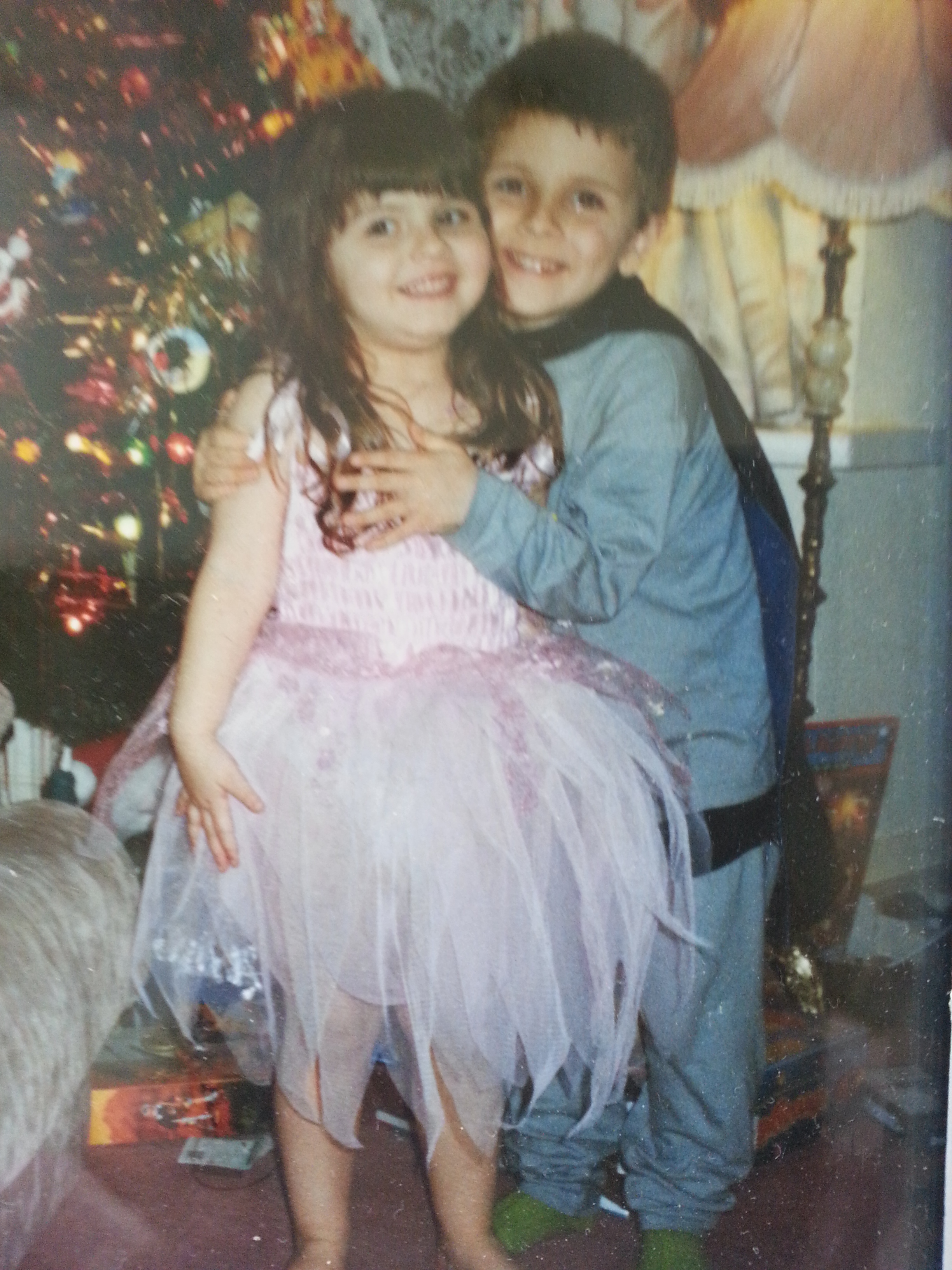 Farrah dressed up and stood with her loving brother in front of the Christmas Tree